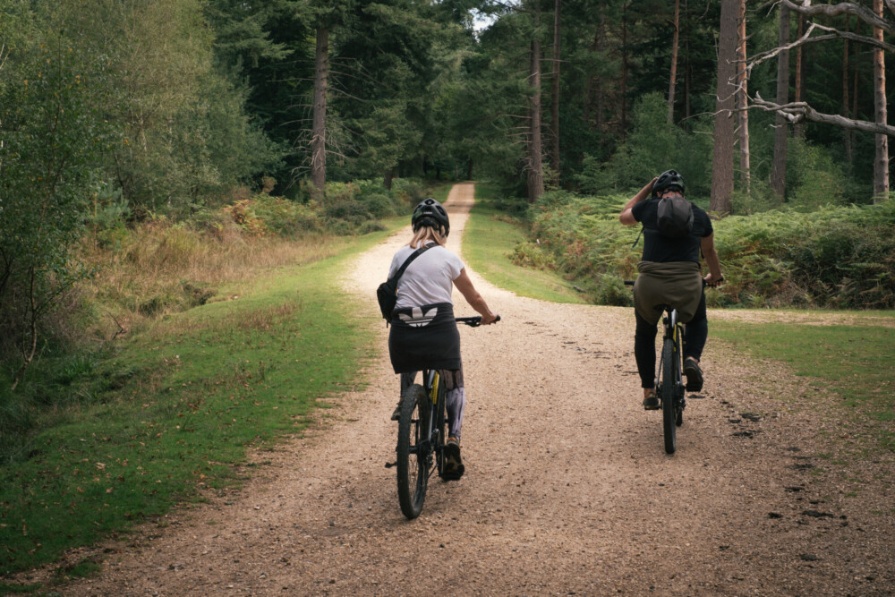 couple cycling on new forest trail